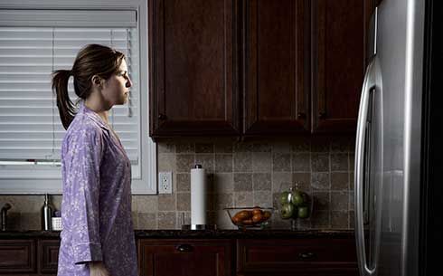 Woman staring at fridge during a power oitage